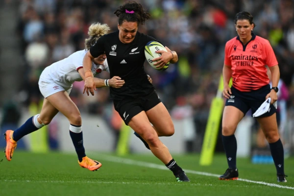 rugby player with football scrunch socks running on a field