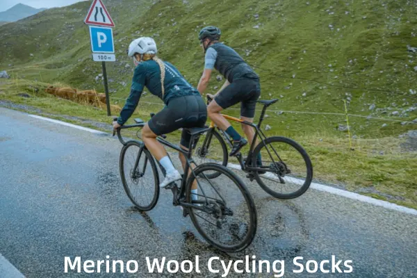 Cyclists wearing merino wool cycling socks on a wet mountain road