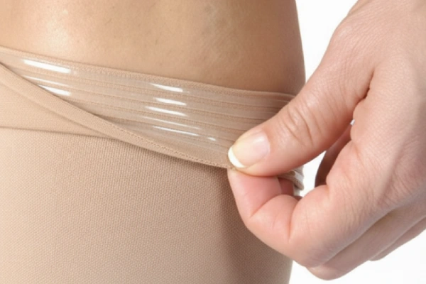 Close-up of a silicone band on a knee-high compression sock to prevent slipping.