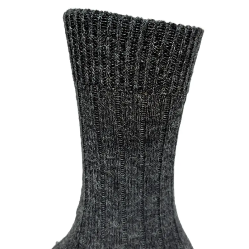 Thick alpaca wool socks with a detailed view of the ribbed cuff and knit texture