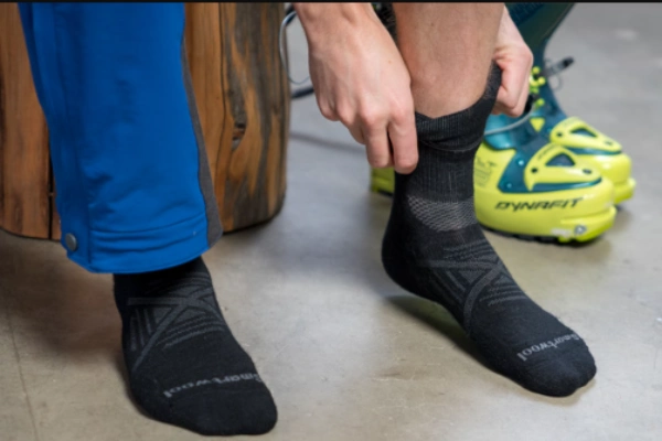 Skiing and snowboarding socks with features like reinforced fabric, shin padding, and flat seams.