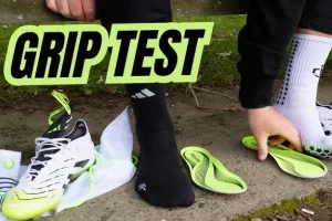 Athlete, trainer, and facility manager reviewing grip socks across tile, wood, and mat surfaces