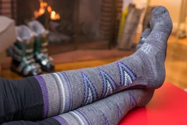 Breathable merino ski socks with ventilation mesh panels designed for moisture wicking during long park sessions