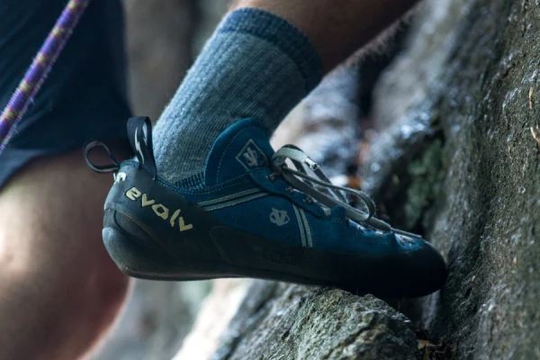 Climber gearing up with climbing shoes and climbing socks for optimal performance