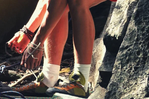 Modern climbing shoes with thin, snug fitting climbing socks providing comfort and protection