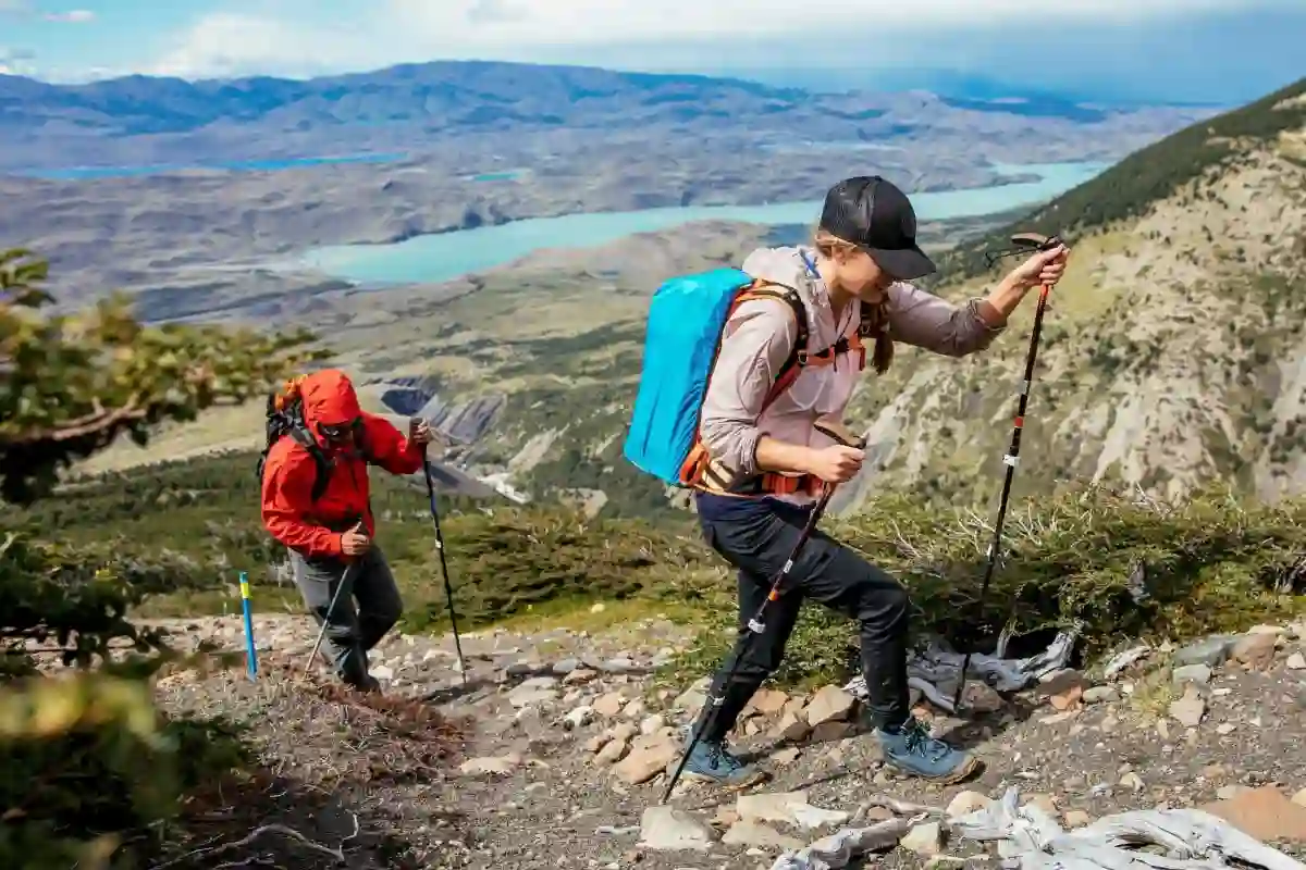 Two hikers testing their hiking wool socks on a steep, rocky mountain trail