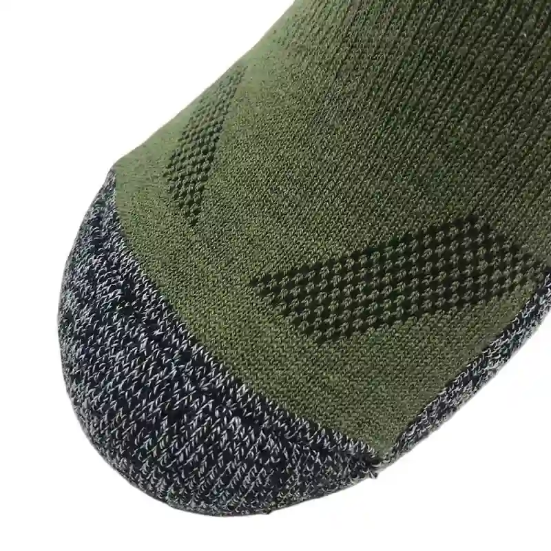 Close-up detail of the reinforced toe and breathable mesh on green summer hiking socks