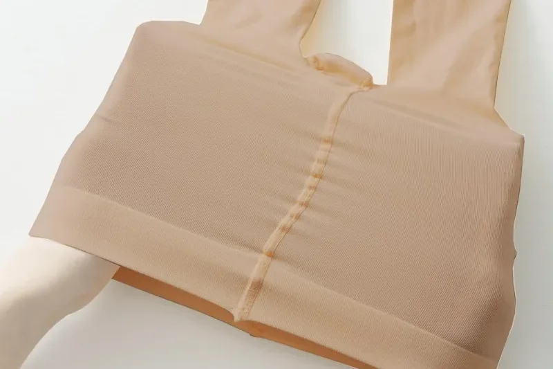 Close-up of a dancer’s waist and legs showing the soft waistband and microfiber fabric of dance tights