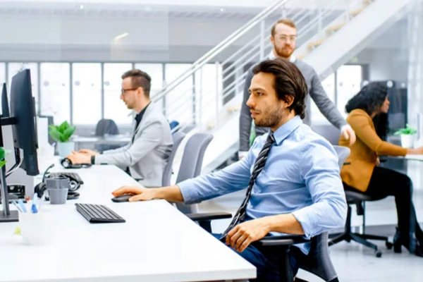 Office employees sitting at desks illustrating supportive socks use for long workdays