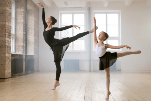 Ballet dancers showcasing Ballet Grace no show socks for elegant footwork in dance studio