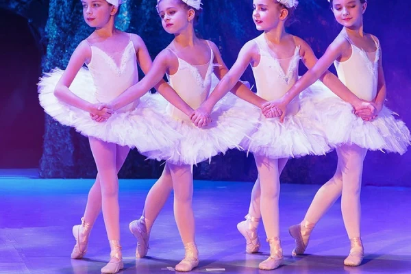 Young ballet performers on stage wearing coordinated dance tights for competition teams