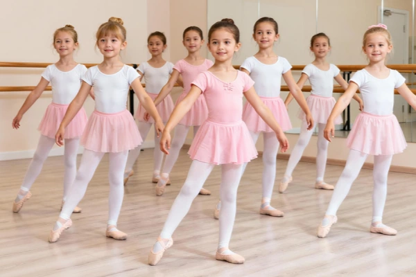 Ballet students in studio class wearing uniform dance tights for daily training