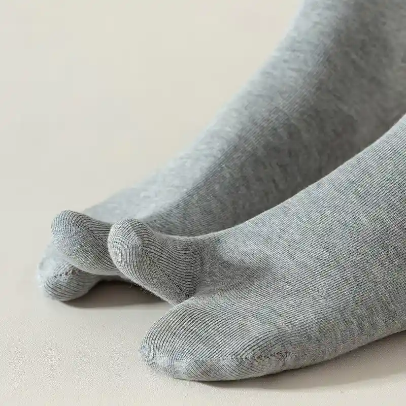 Close-up of grey tabi socks showing split-toe construction
