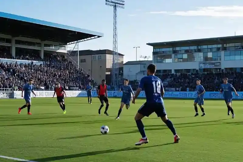 Players in soccer grip socks competing during packed stadium match