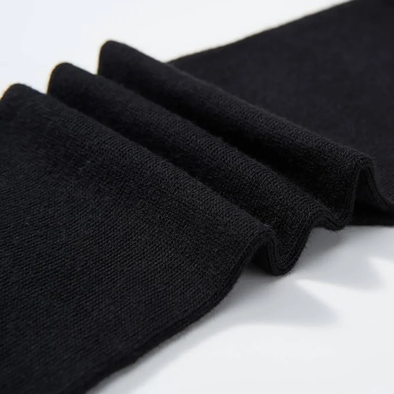 Folded black tabi sock fabric showing knit texture and thickness