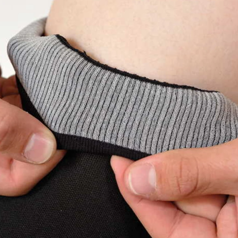 Calf compression sleeve cuff stretched to reveal the grey anti slip yarn technology lining