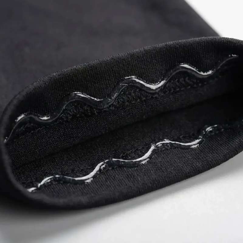 Close up of calf compression sleeve interior showing a wavy non slip silicone grip cuff