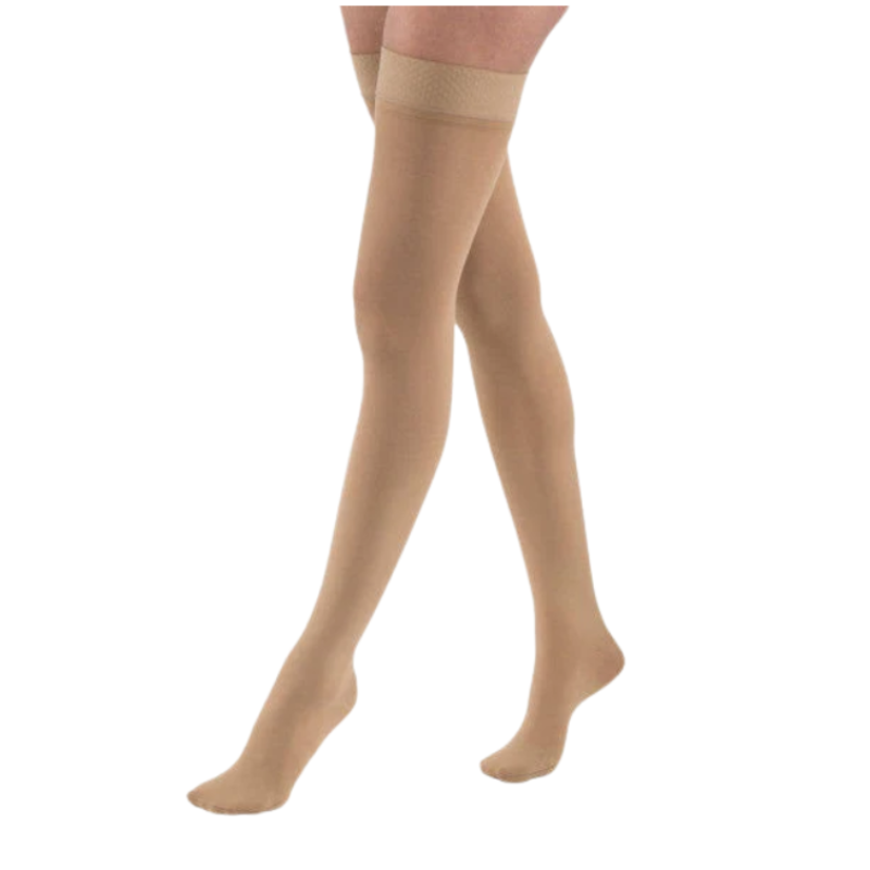 Thigh high medical compression stockings in beige featuring a silicone stay up top band