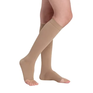 Person wearing beige open toe varicose veins compression socks for lower leg support