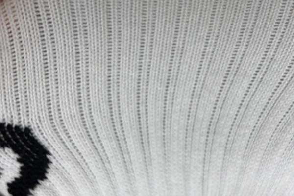 Soccer grip socks breathable mesh fabric and ribbed design close up for ventilation on leg