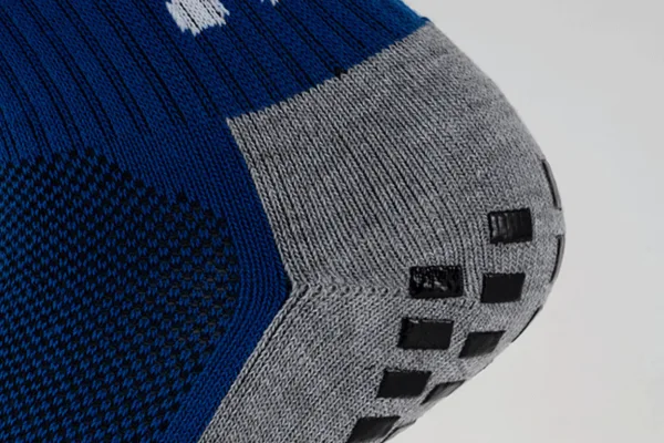 Soccer grip socks heel showing square black anti slip pads for traction