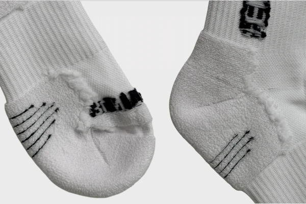 White soccer grip socks reinforced toe and sole details for durability and support