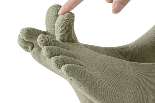 Macro close up of a five toe sock's finished toe seams with no loose thread