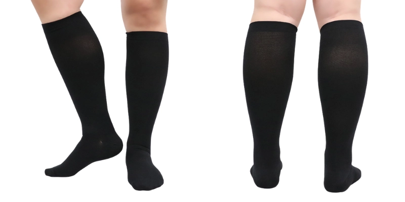 Plus size and wide calf compression socks in black displaying front and back views on legs