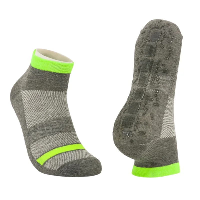 Professional grey trampoline socks with neon green accents and reinforced non-slip sole patches