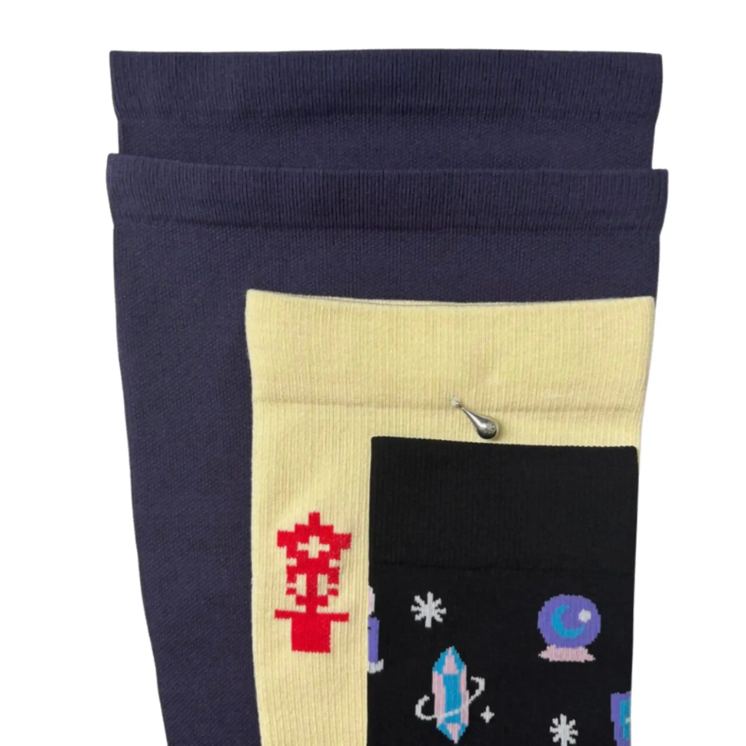 Three different sizes of compression socks stacked to show proportional widening of foot and calf