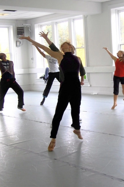 Dance studio class with students on the studio floor