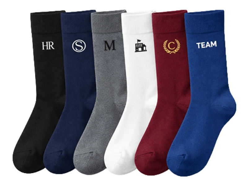 A row of colorful crew dress socks knitted with custom logos on the cuffs