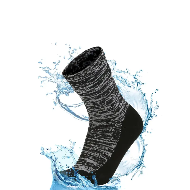 Black and grey crew length waterproof socks for hiking surrounded by dynamic water splash