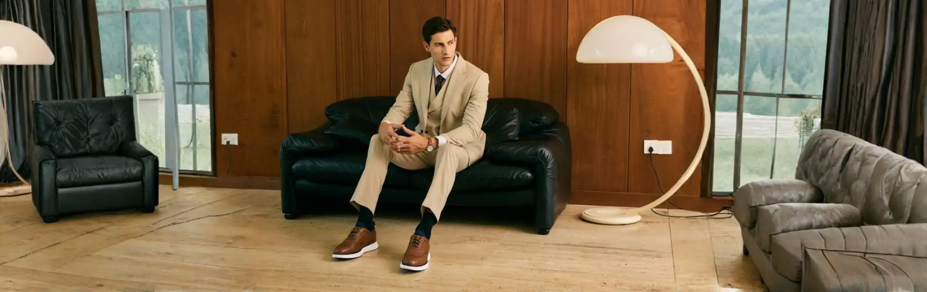Business man wearing dress socks with a beige suit and leather shoes