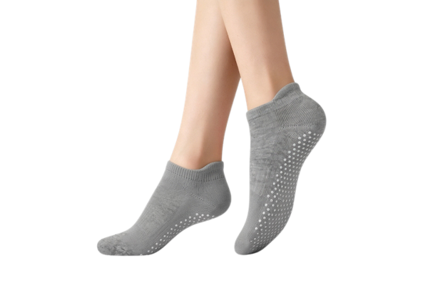 Low cut grip socks with full silicone traction pattern worn on feet
