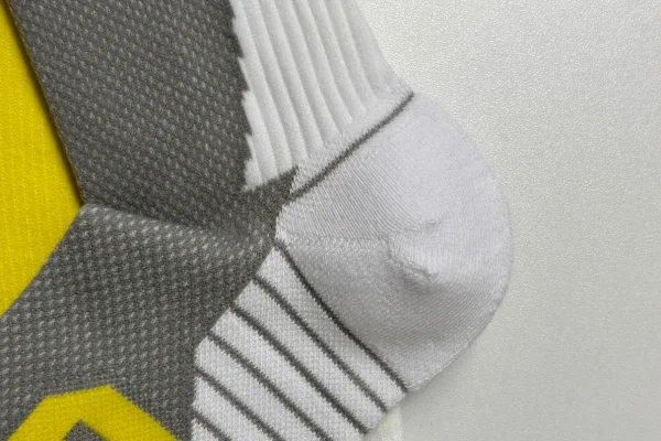 Close-up of technical sock Y-heel construction designed for secure fit and blister prevention