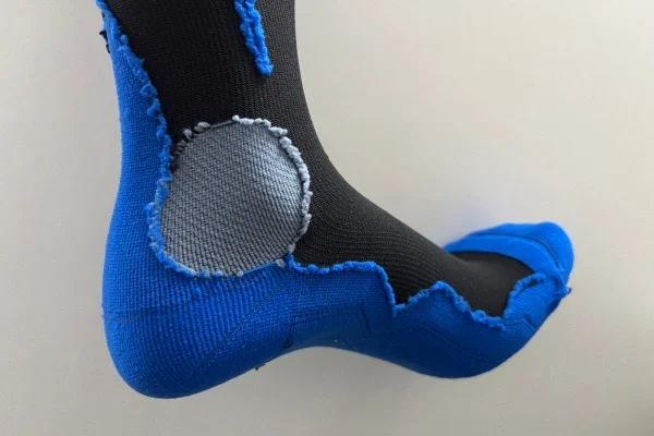 Hiking sock with added Achilles cushion and boot contact protection