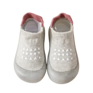 Grey knitted baby sock shoes with pink trim and non slip dots
