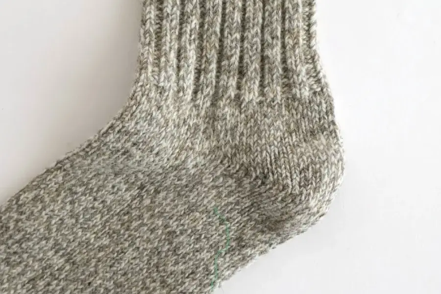 Coarse gauge thick knit wool sock showing heavy yarn construction